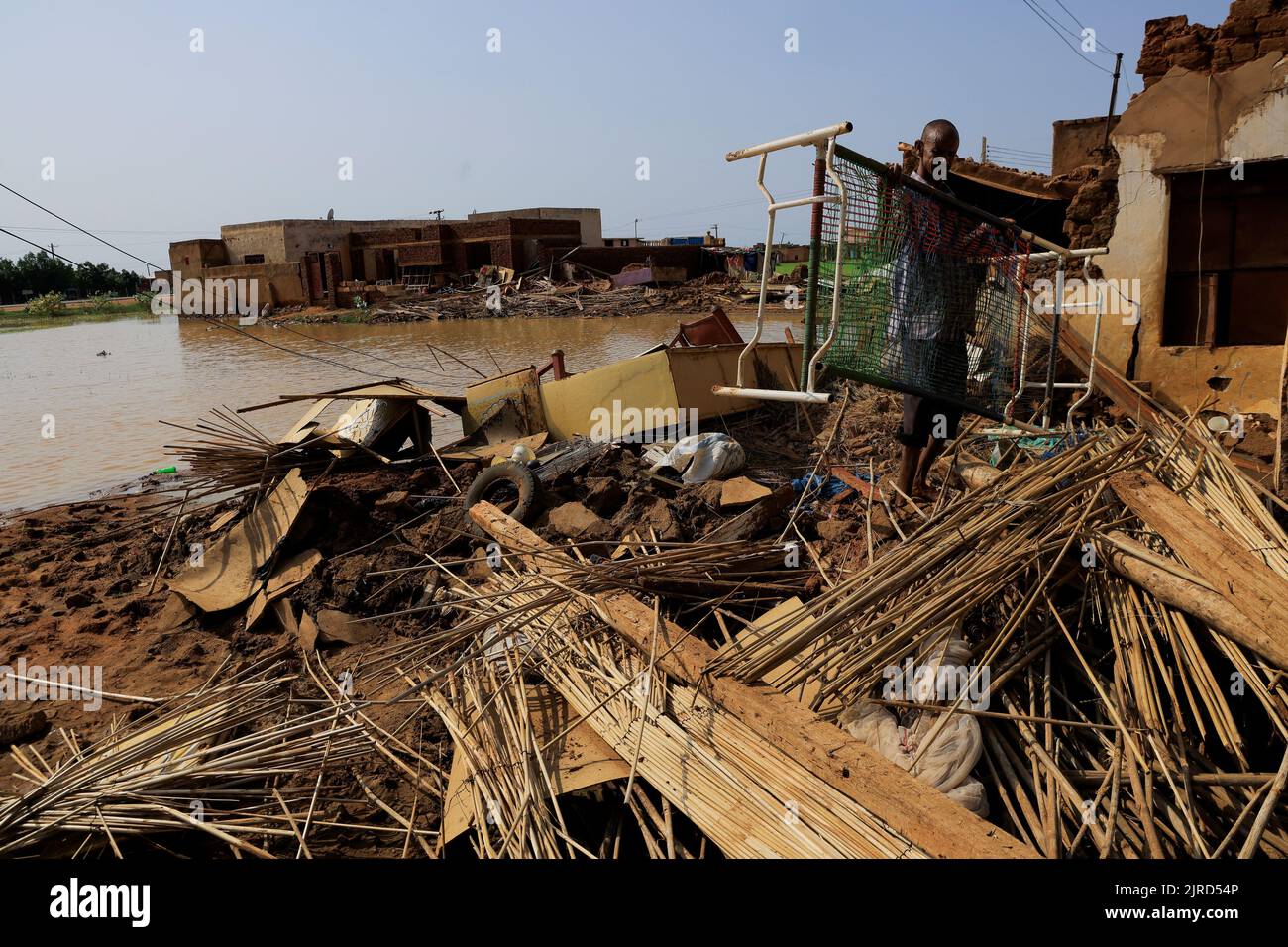 A man collects his belongings after sustaining water damage to his house during floods in Al-Managil locality, in Jazeera State, Sudan August 23, 2022. REUTERS/Mohamed Nureldin Abdallah Stock Photo