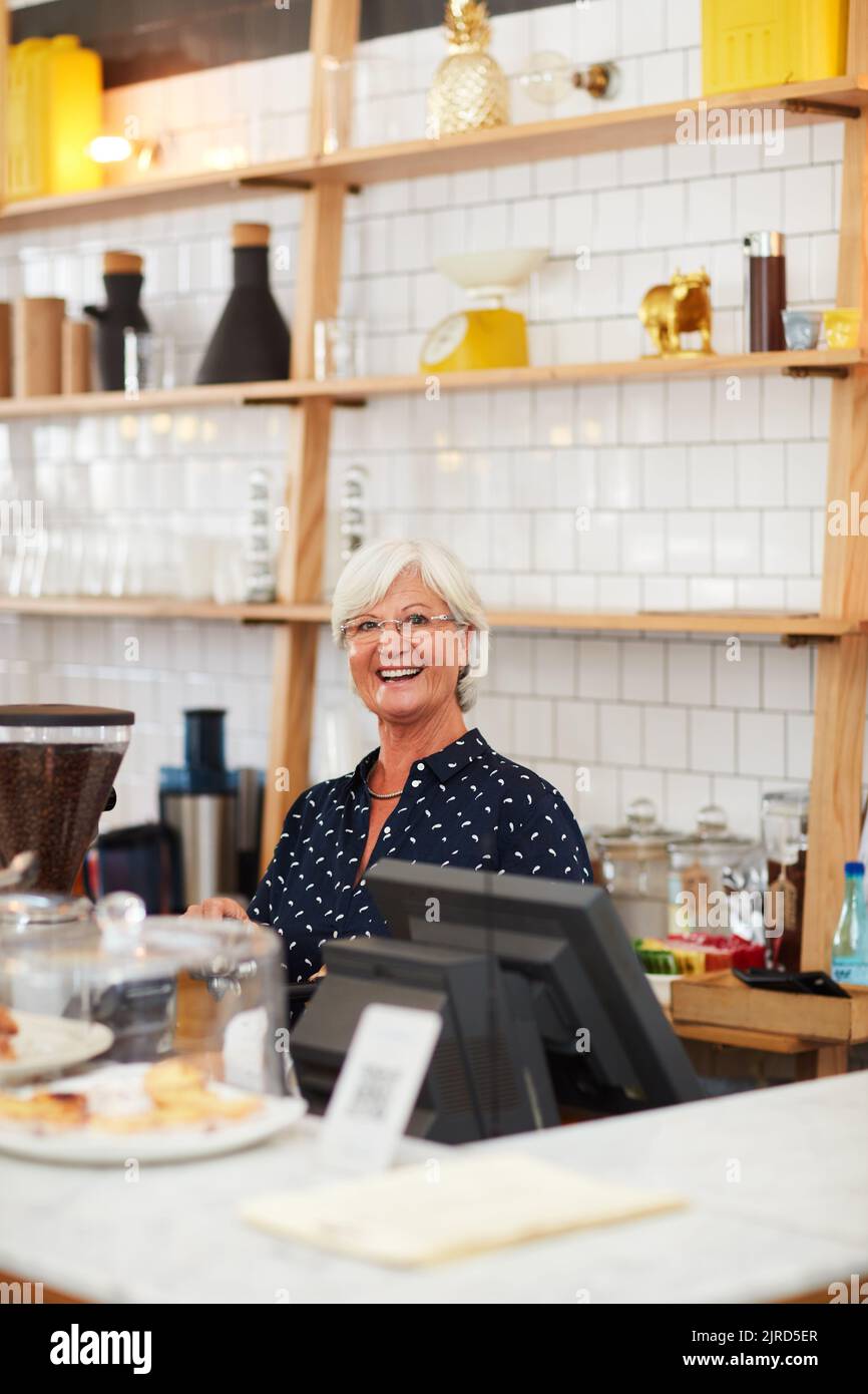 Dont ever stop chasing your dreams. Portrait of a senior woman working in a coffee shop. Stock Photo