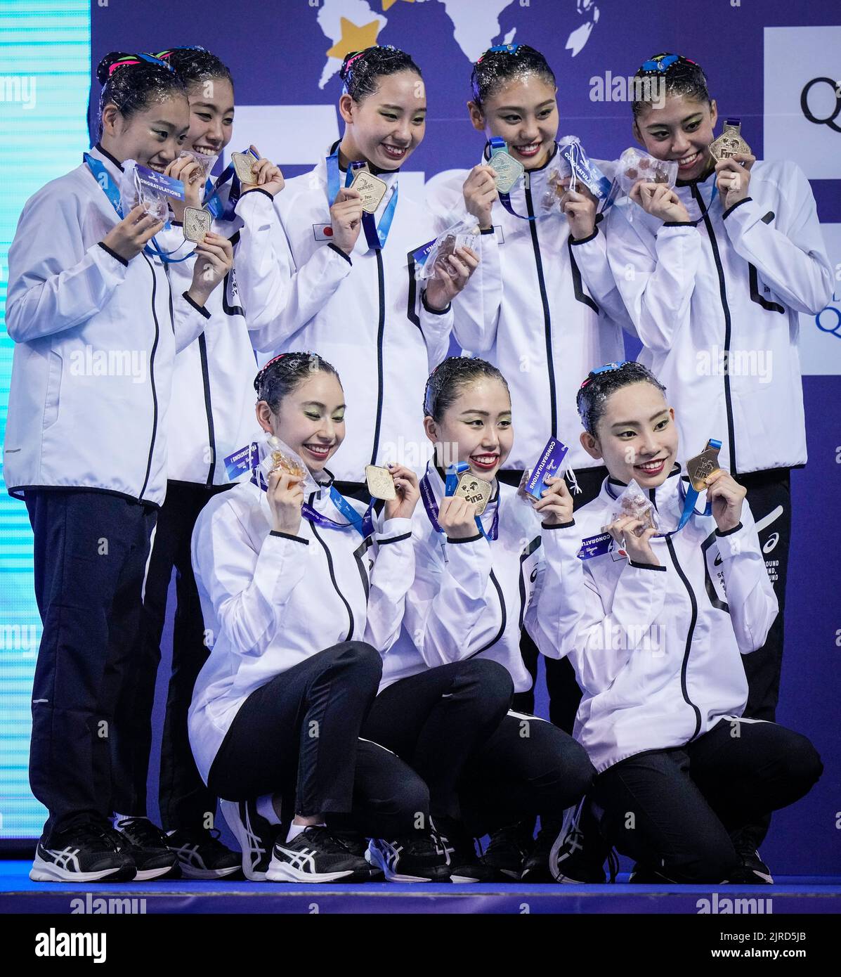 Team Japan poses with their medals after the team technical program at