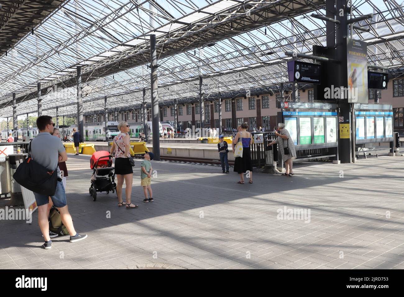 Helsinki, Finland - August 20, 2022: View of the platform area with waiting passengers at the Helsinki central railroad station. Stock Photo