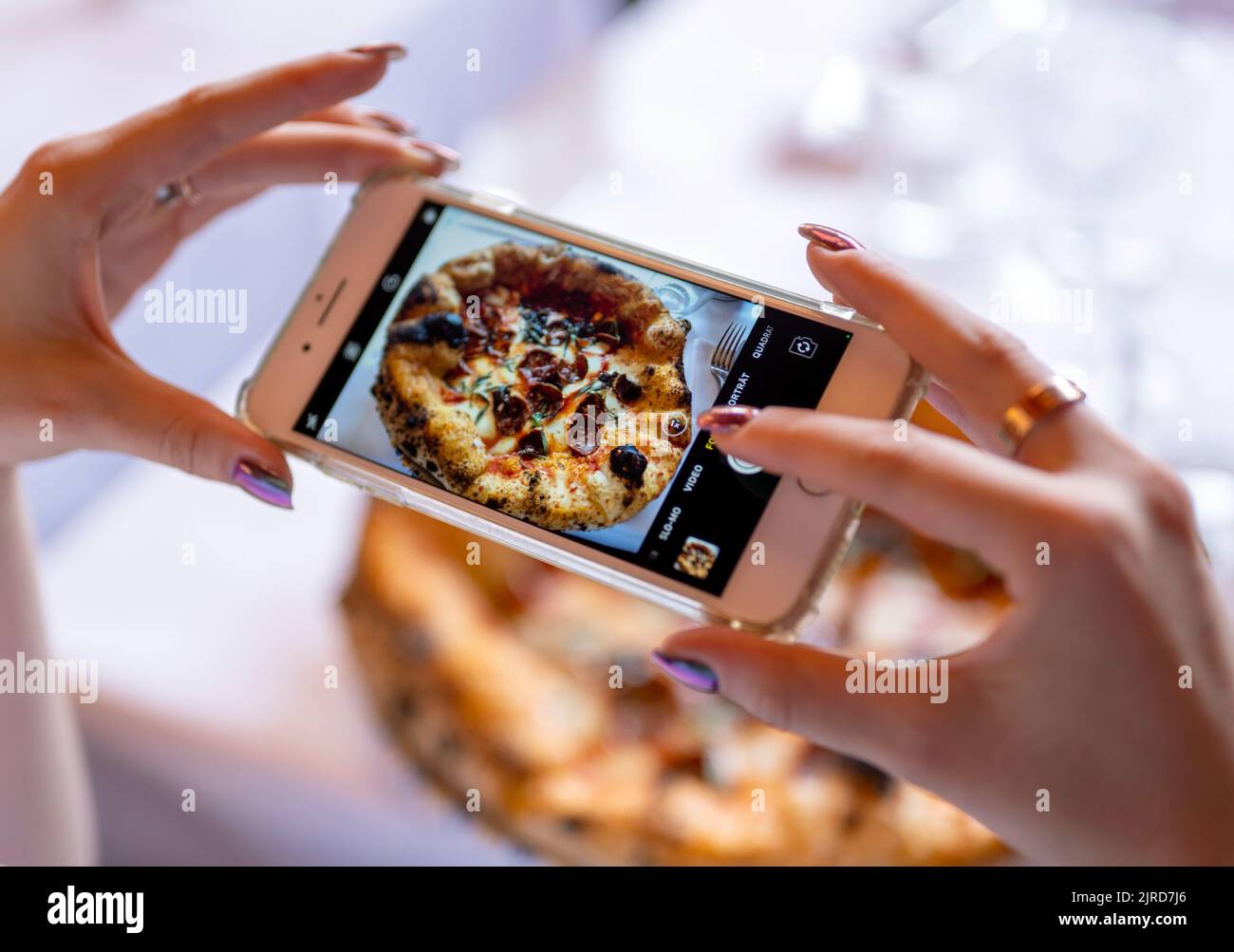 Berlin, Germany. 19th Aug, 2022. A woman takes a picture with her smartphone of the dish 'Drop it like it's hot' at the restaurant 'Coccodrillo' in Weinbergspark. The main thing 'Instagrammable' seems to be the motto of some new eateries. (to dpa-Korr 'Overwhelming': How the Instagramming of the gastronomy world continues') Credit: Monika Skolimowska/dpa/Alamy Live News Stock Photo