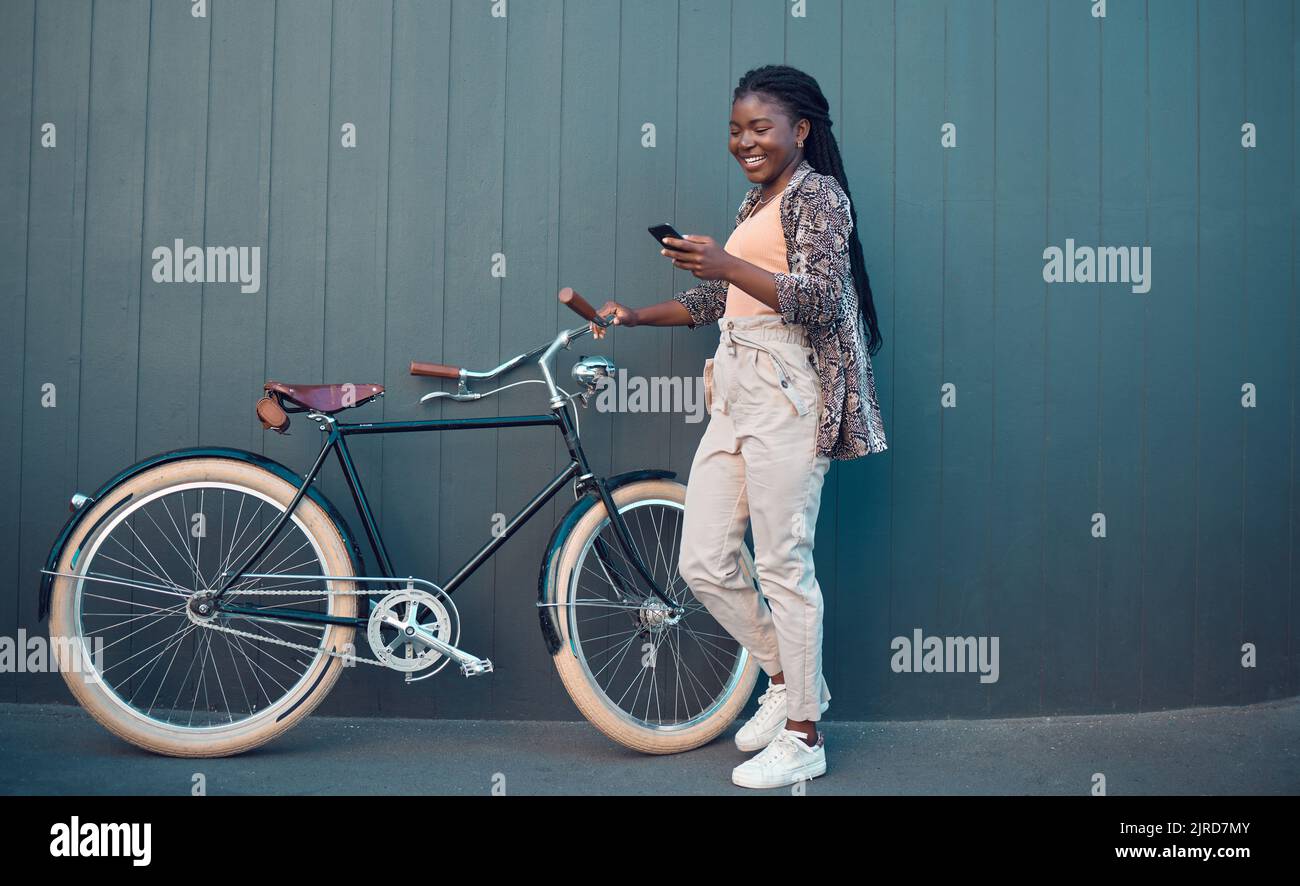 Girl, relax with bicycle and using smartphone app, social media and doing a internet or web search. Student uses her bike for health, fun workout or Stock Photo