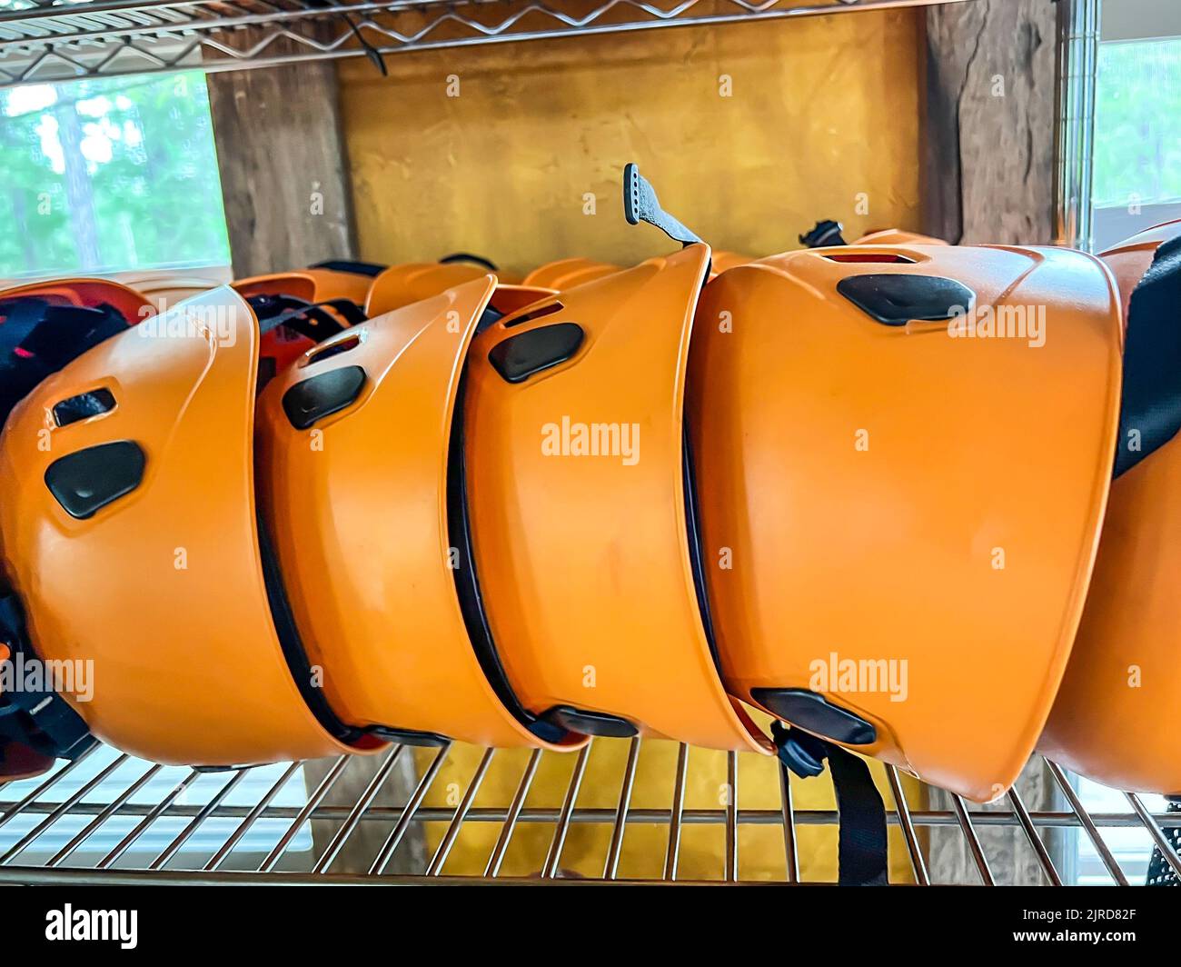 Row of helmets ready for use at a high ropes and climbing course Stock