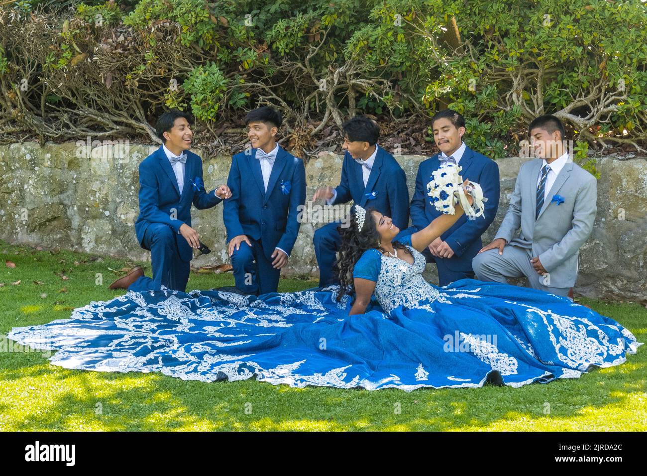 Hispanic wedding party posing for a photo in a garden setting in Santa Barbara, California. Stock Photo