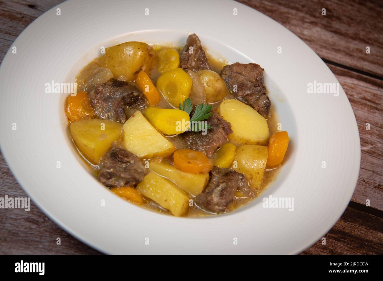Recipe for beer and mustard beef chuck stew with potatoes, turnips and carrots Stock Photo Alamy