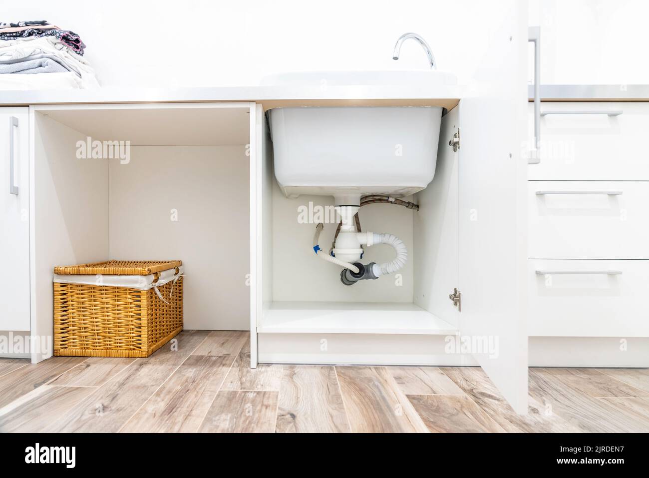 Under the sink view in laundry room Stock Photo Alamy
