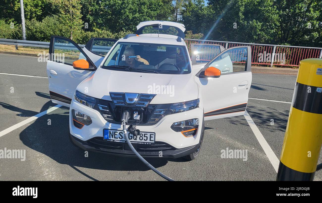 HEILIGENHAUS, NRW, GERMANY - AUGUST 10, 2022: Heiligenhaus, Nrw, Germany - August 10, 2022: Brand new electric Dacia Spring automobile being charged Stock Photo
