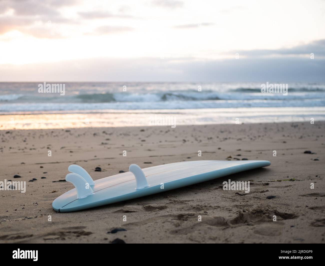 A surfboard left on the beach Stock Photo - Alamy