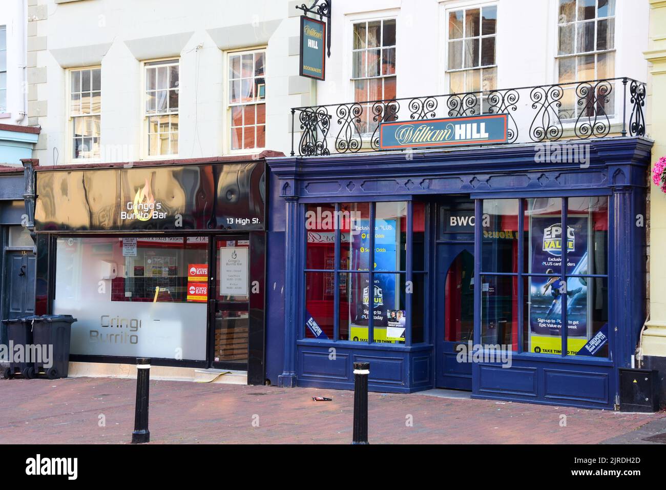 Holywell, Flintshire, UK: Aug 14, 2022: William Hill Bookmakers and Gringos Burrito Bar are neighbours on the High Street Stock Photo