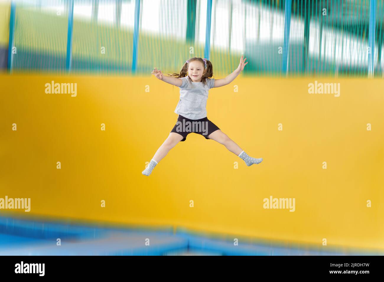 Happy little girl jumping on trampoline in fitness center Stock Photo Alamy