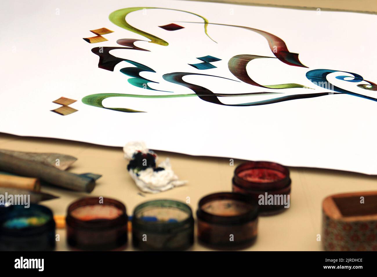 A written colorful Arabic calligraphy text. Stock Photo