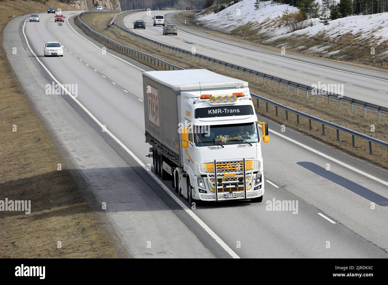 Volvo FH KMR-Trans pulls Freja semi trailer in slow motorway traffic on a day of spring, elevated view. Salo, Finland. April 18, 2022. Stock Photo