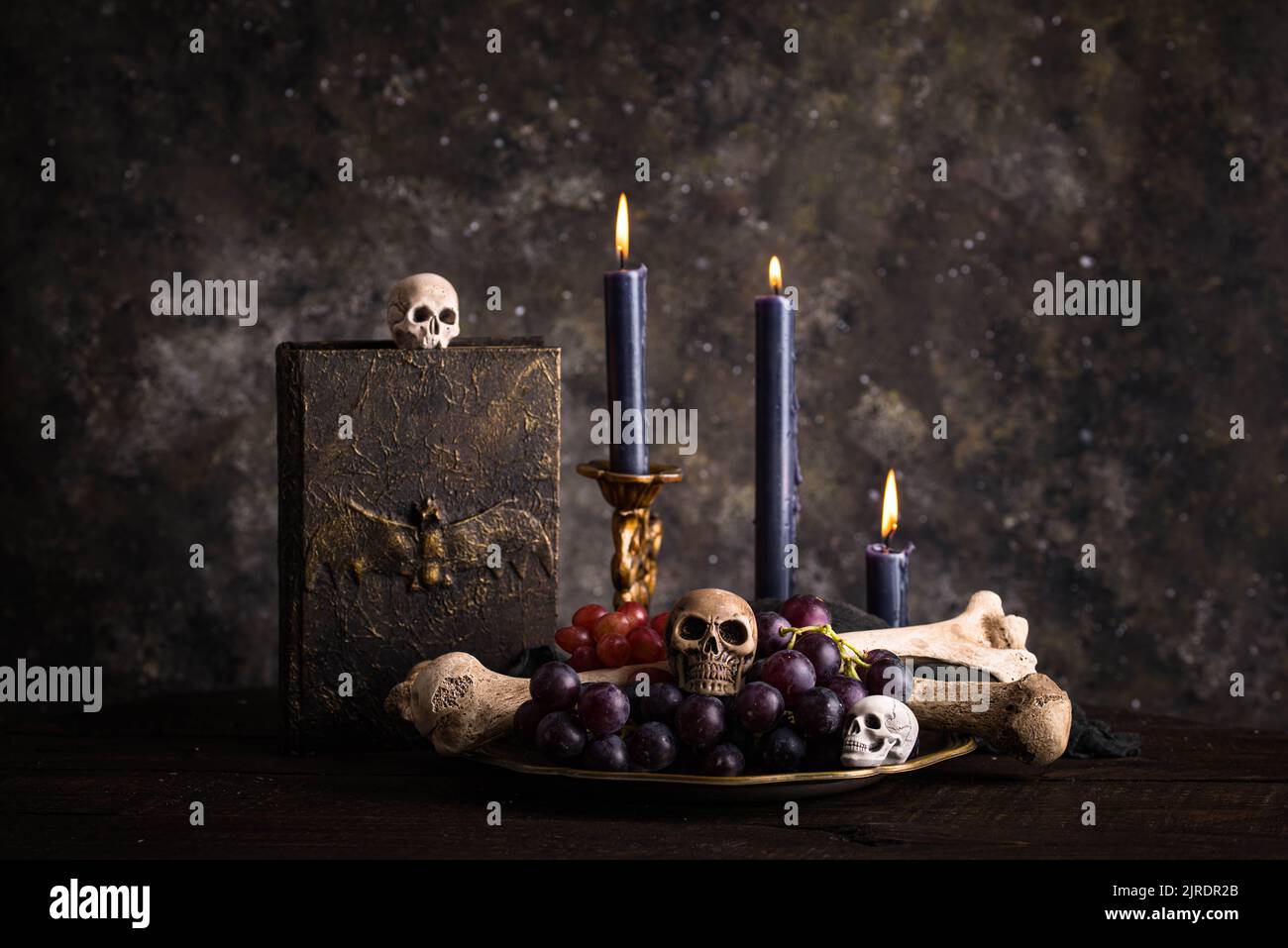 Halloween still life with skull, bones and cake Stock Photo Alamy
