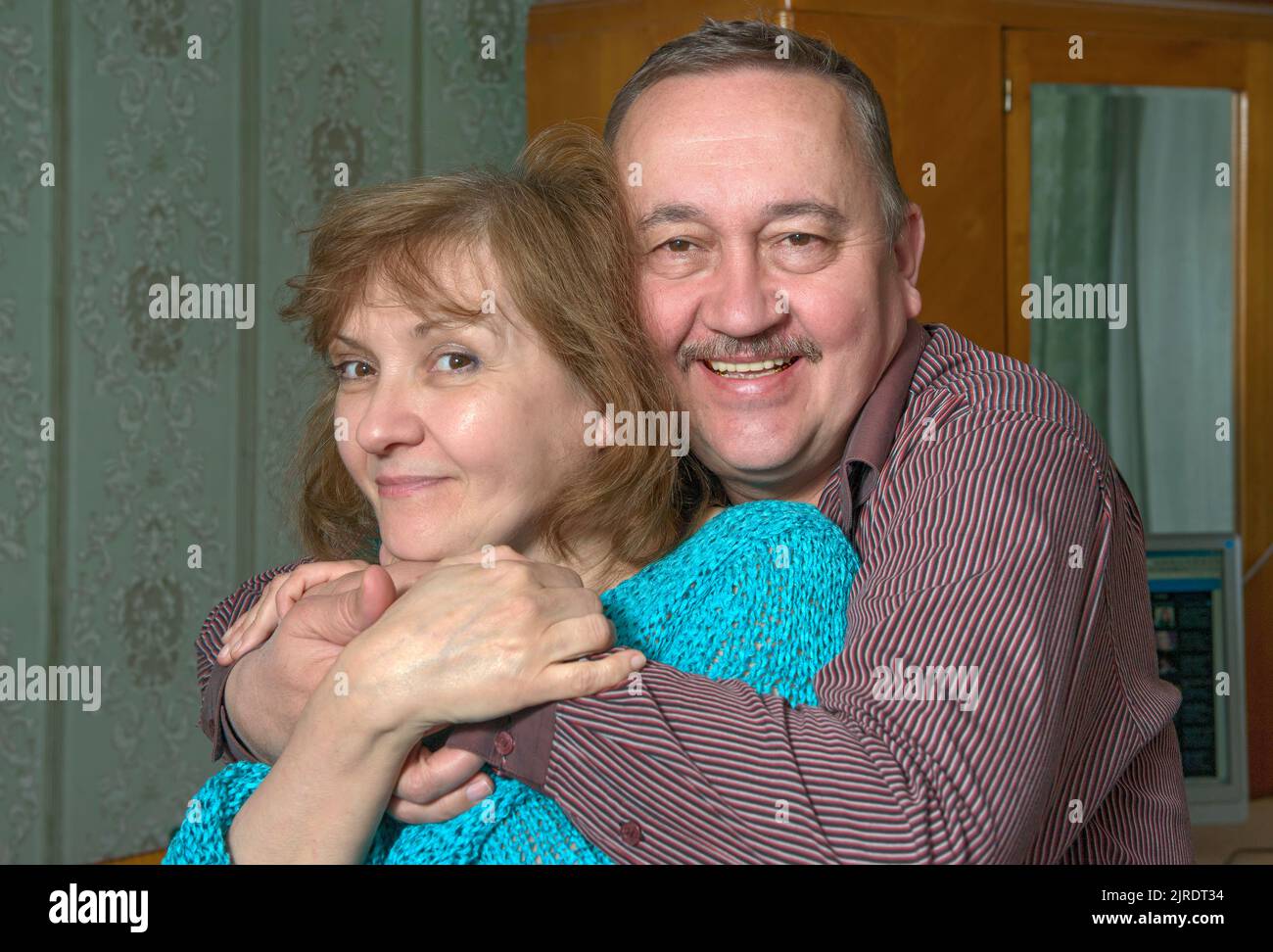 Closeup head and shoulders portrait of elderly pair that are friendly