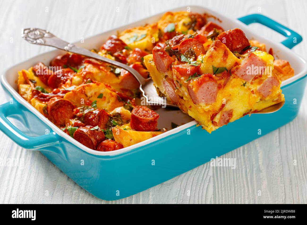 close-up of english muffin sausage egg bake in baking dish on white ...