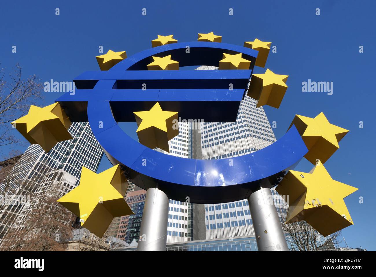 A low angle shot of the Euro sign in front of the central bank building in Frankfurt am Main, Germany Stock Photo