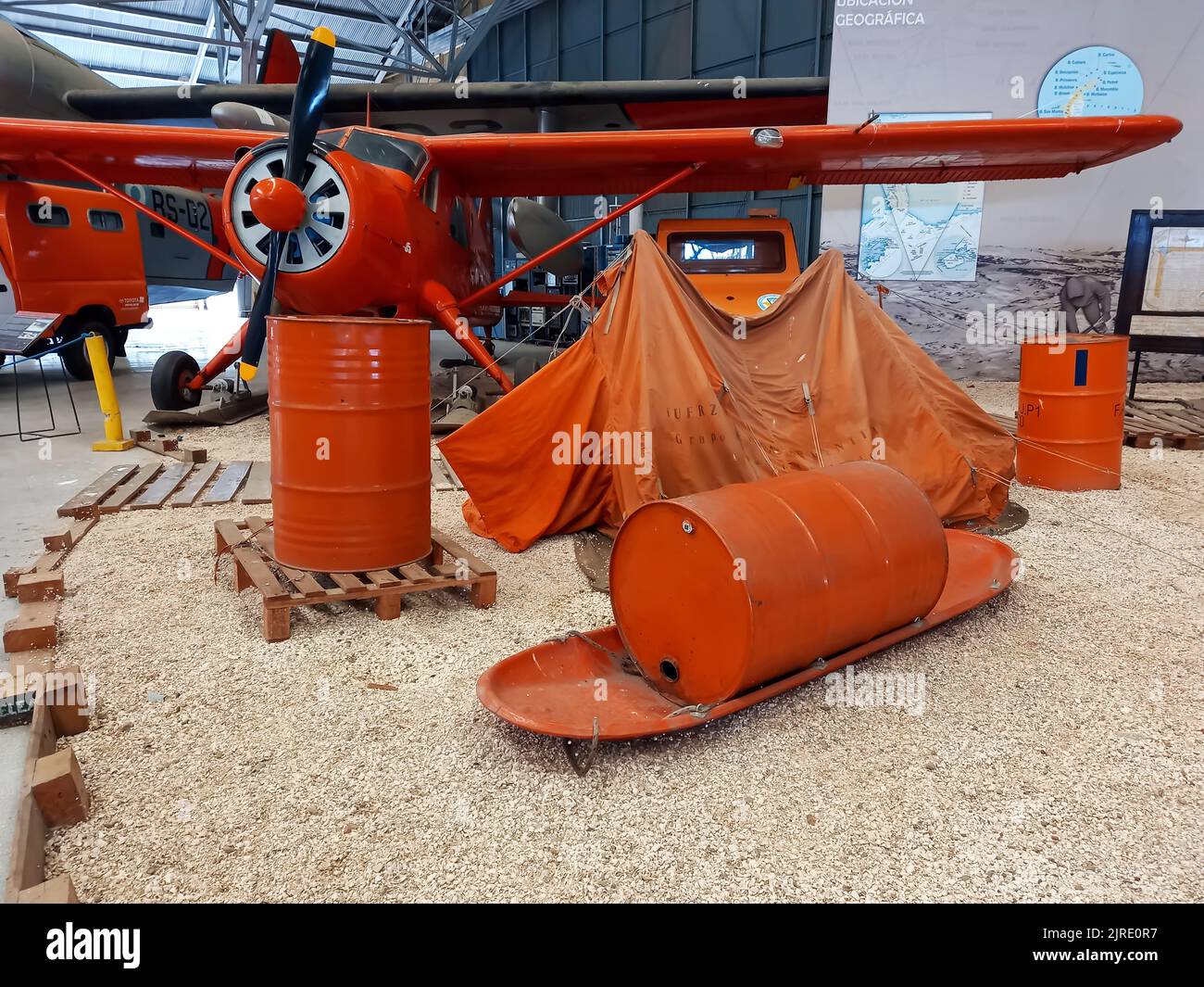 Moron, Argentina - Mar 26, 2022: Representation of an Antarctic camp. Orange equipment. Airplane, tent, tanks, sled. National Aeronautic Museum Stock Photo
