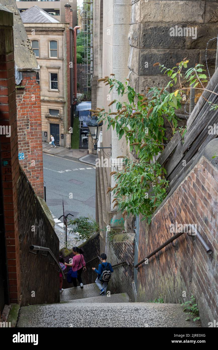 A family walk down the famous Dog Leap Stairs in the city of Newcastle upon Tyne, UK. Stock Photo