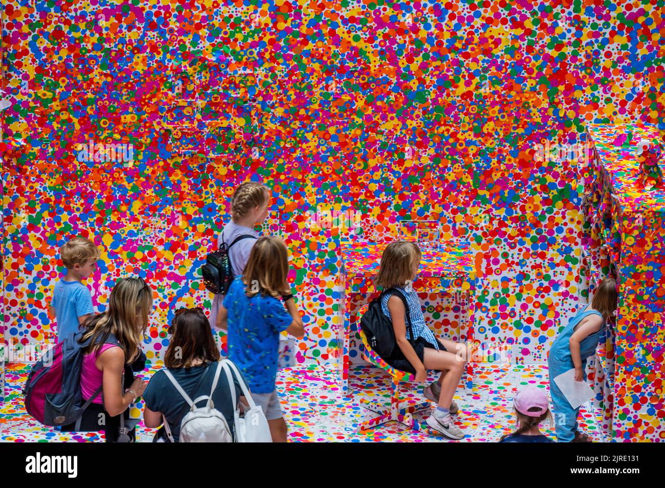 London, UK. 23rd Aug, 2022. The last chance this week to take part in the UNIQLO Tate Play: The obliteration room by Yayoi Kusama, where visitors transform a completely white domestic apartment into a sea of colourful dots. Visitors are given a sheet of colourful ‘dot' stickers to help bring the space to life in the Turbine Hall. Credit: Guy Bell/Alamy Live News Stock Photo