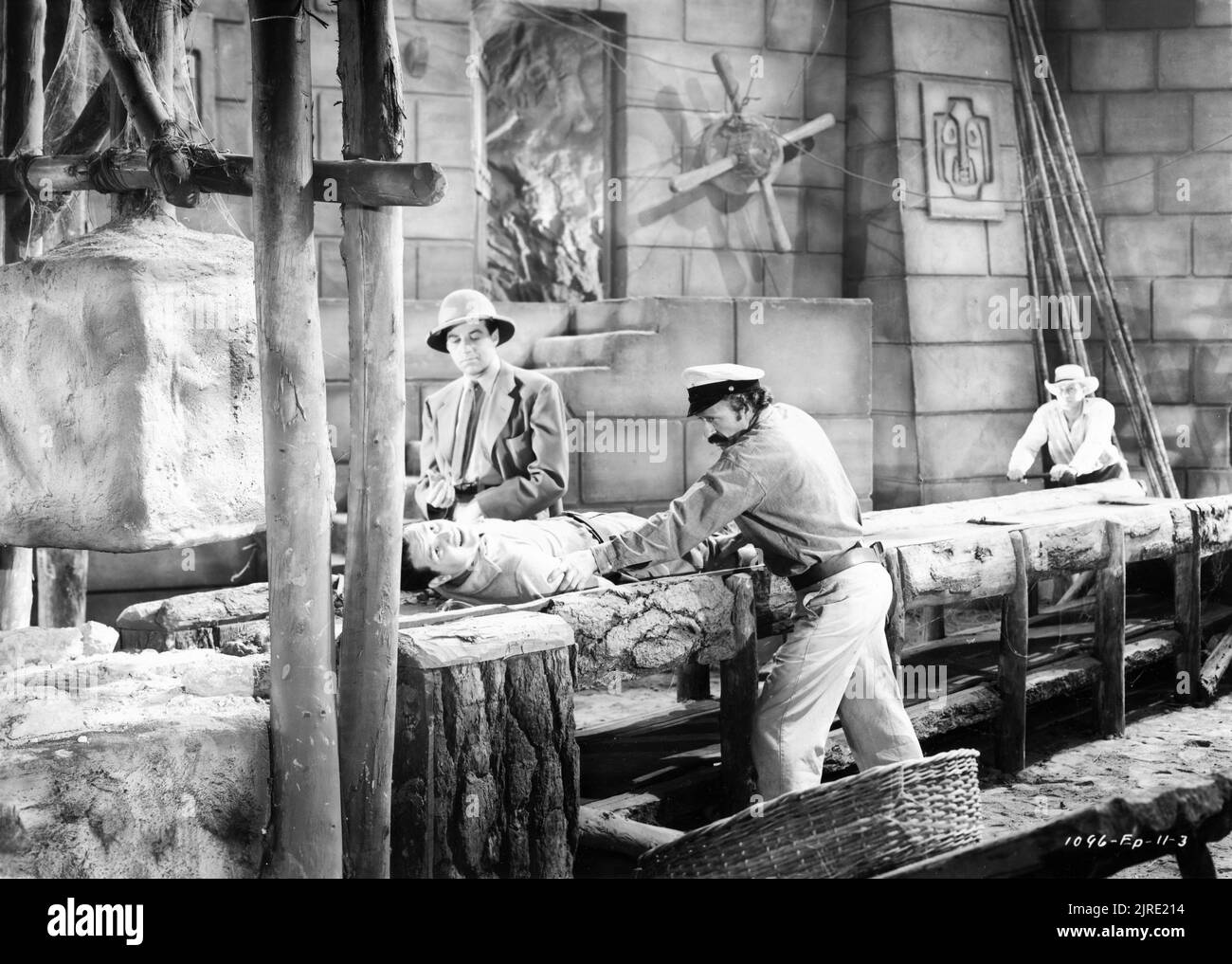 GERALD MOHR as Slick Latimer AL TAYLOR as Claggett and BUD GEARY as Brock torture TOM NEAL as Jack Stanton in Episode 11 of the 15 Chapter Serial JUNGLE GIRL 1941 directors JOHN ENGLISH and WILLIAM WITNEY based loosely on the novel by Edgar Rice Burroughs set decoration Morris Braun associate producer Hiram S. Brown Jr. Republic Pictures Stock Photo