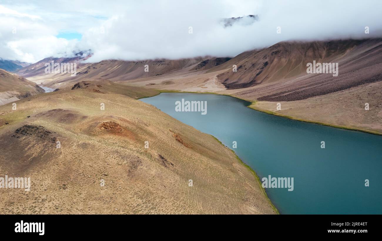 aerial panoramic of Chandra Taal Lake and Spiti Valley Mountains on cloudy day in Himachal Pradesh India Stock Photo