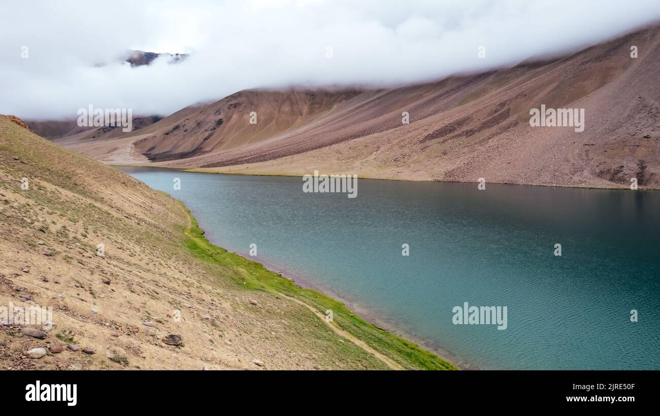 river, extreme places, beautiful, summer, day, sunny, plains, meadow, upper chandra taal lake, sightseeing, tourism, travel, nature, landscape, clouds Stock Photo