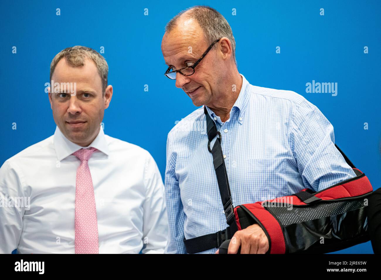 24 August 2022, Berlin: Mario Czaja, CDU secretary general, and Friedrich Merz (r), CDU leader, arrive at a meeting of the CDU federal executive committee. CDU leader Friedrich Merz broke his collarbone while on vacation in Bavaria and wears a sling to immobilize his arm. Photo: Fabian Sommer/dpa Stock Photo