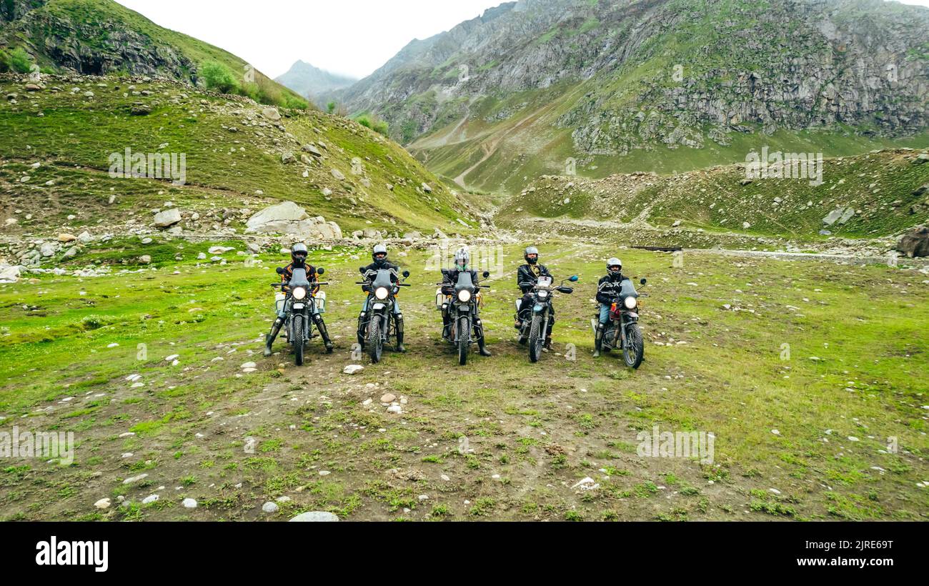 5 local motorcycle touring bikes in a green mountain valley of Spiti in Himachal Pradesh India