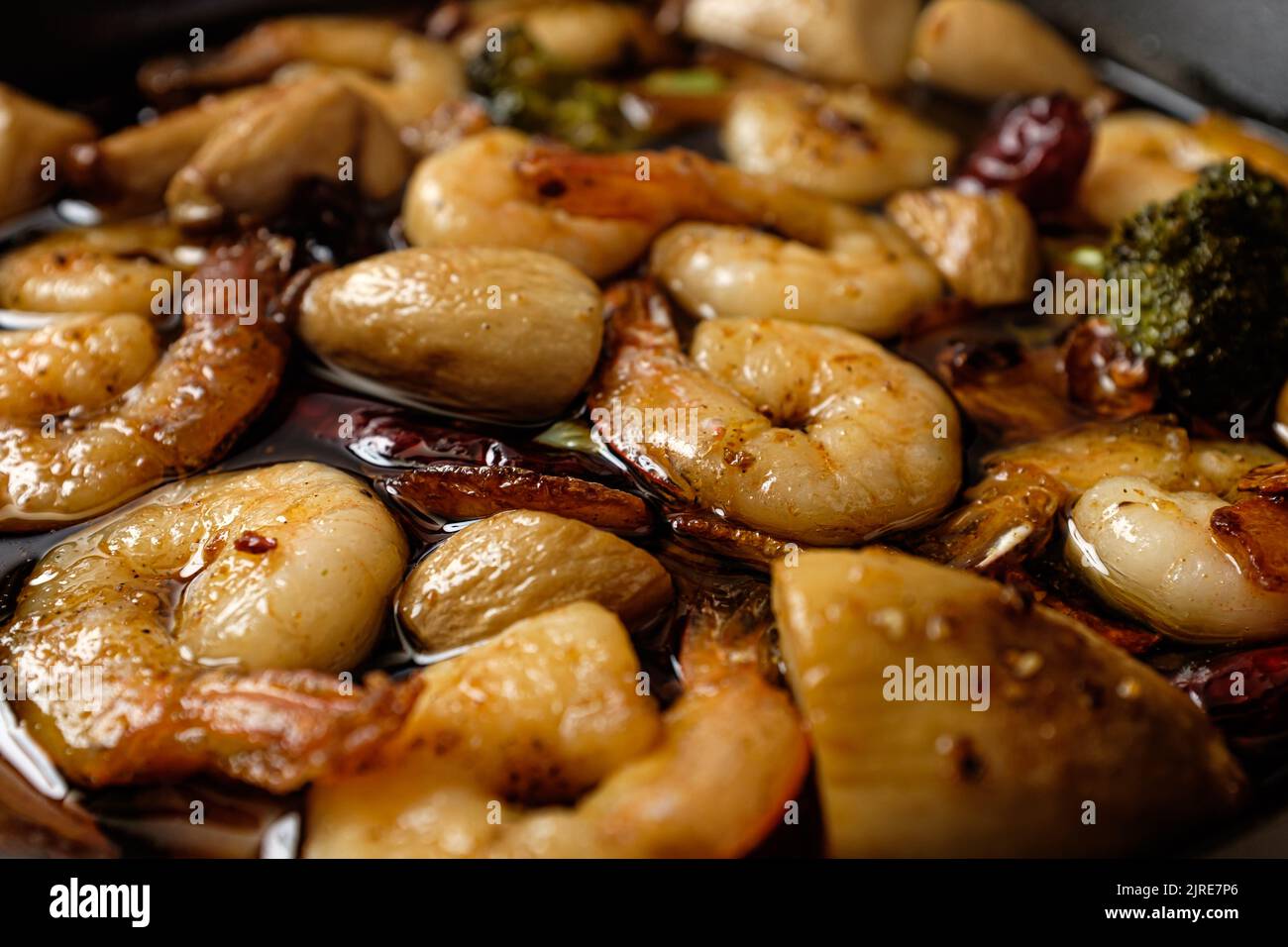 Garlic and peperoncino flavored olive oil. food with shrimp. spanish food culture Stock Photo