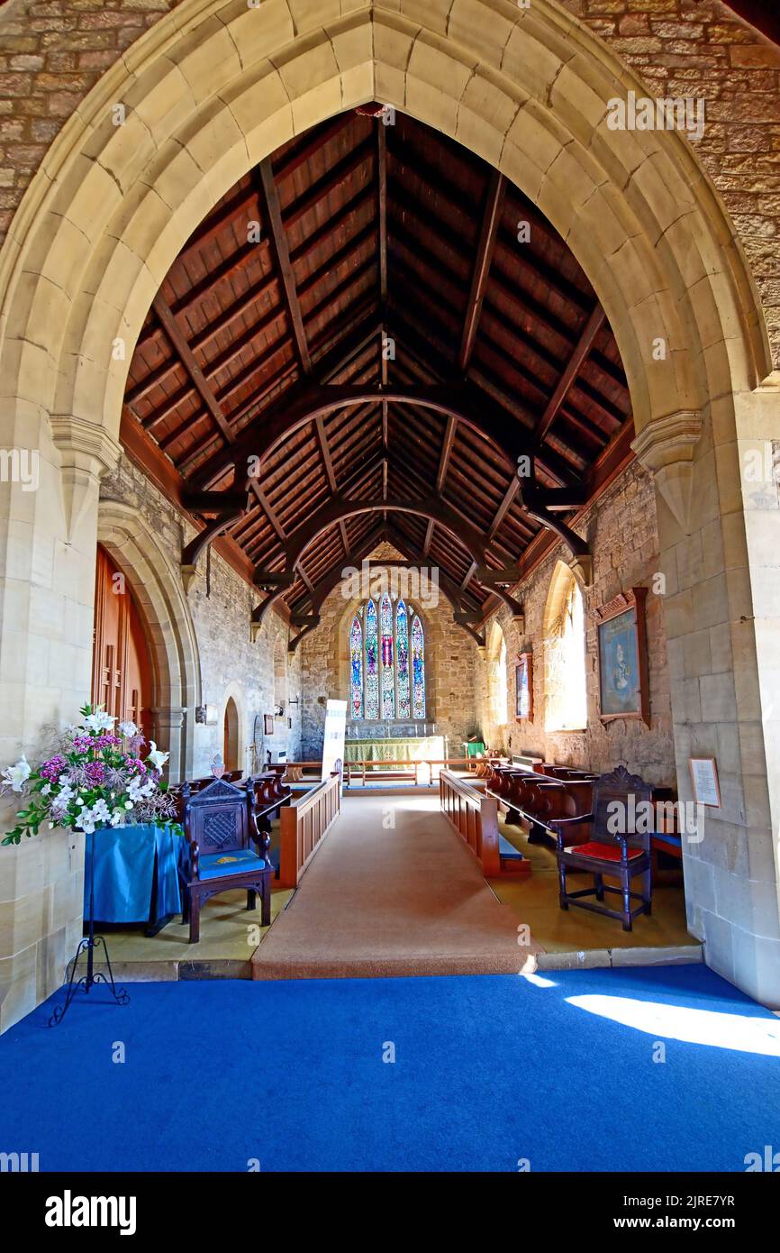 Newbiggin by the sea Northumberland beautiful seaside village with 13th century St Batholomews church interior view looking east towards the superb Ea Stock Photo