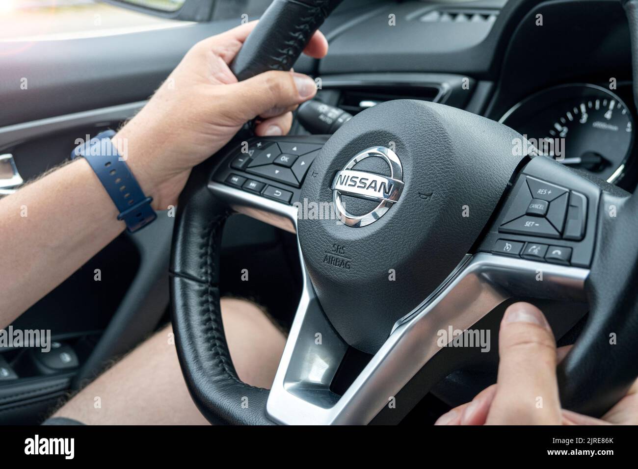 BERLIN - AUG 20: Close-up of the steering wheel Nissan Qashqai car with logotype in Berlin, August 20. 2022 in Germany. Nissan Motor is a Japanese mul Stock Photo