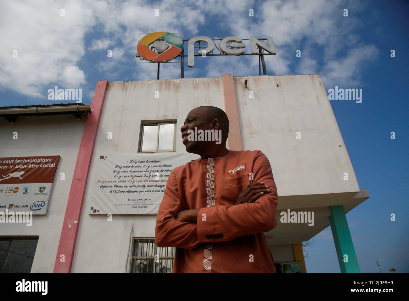 Alain Chichi Capo, the inventor of Open G smartphones, which can speak  local Ivorian languages, stands in front of the factory where the  smartphones are manufactured, in Grand Bassam, Ivory Coast July