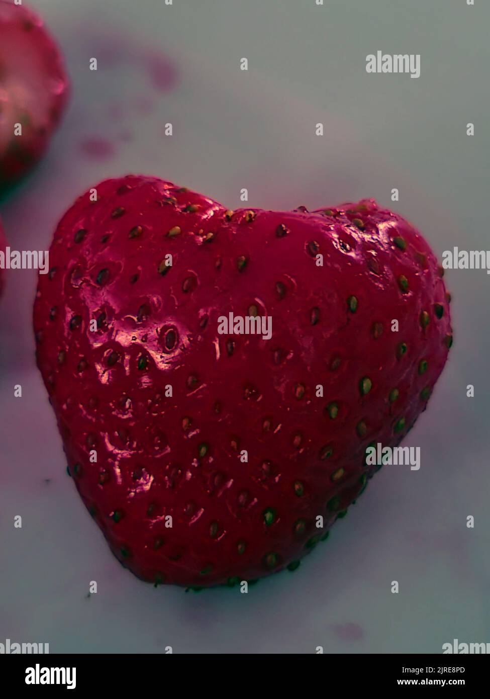 dessert strawberry naturally grown like a heart in abstract metallic optic Stock Photo
