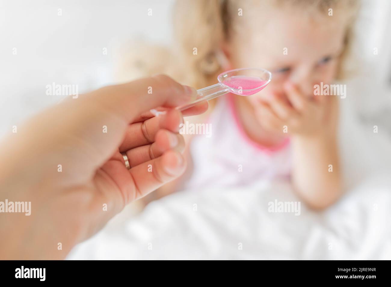 The child refuses to drink syrup. Stock Photo