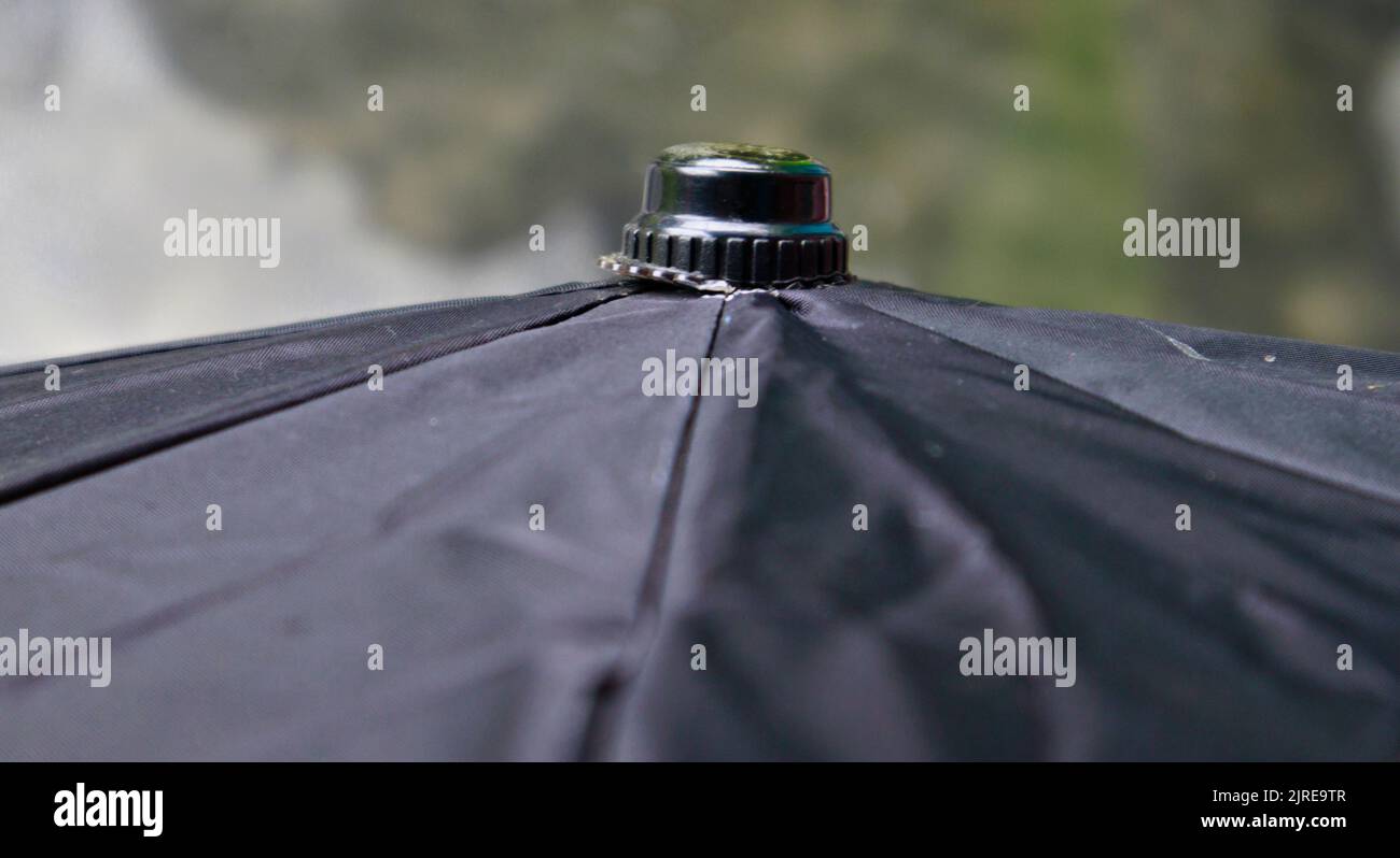 A top of a black umbrella in a sunny day. Stock Photo