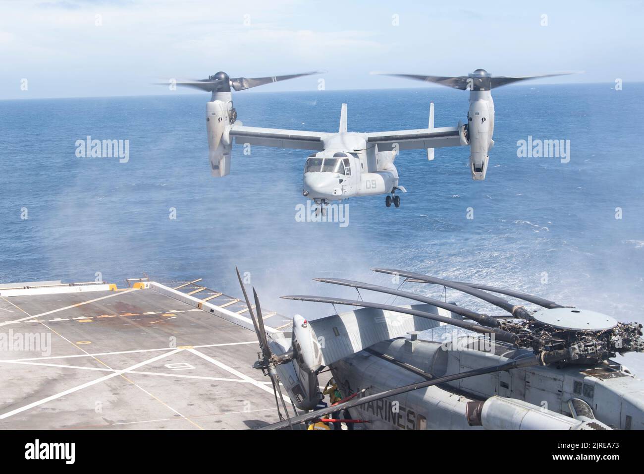 220808-N-FO865-2034    PACIFIC OCEAN (Aug 8, 2022) – An MV-22 Osprey, assigned to Marine Medium Tiltrotor Squadron (VMM) 362 (Reinforced), 13th Marine Expeditionary Unit (MEU), lands on the flight deck of amphibious transport dock ship USS John P. Murtha (LPD 26), August 8. Synchronizing the complementary capabilities of the 13th MEU and USS John P Murtha multiplies the traditional influence of sea power to produce a more competitive and lethal force. John P. Murtha, part of amphibious squadron (CPR) SEVEN, along with 13th Marine Expeditionary Unit (MEU), is currently underway conducting integ Stock Photo
