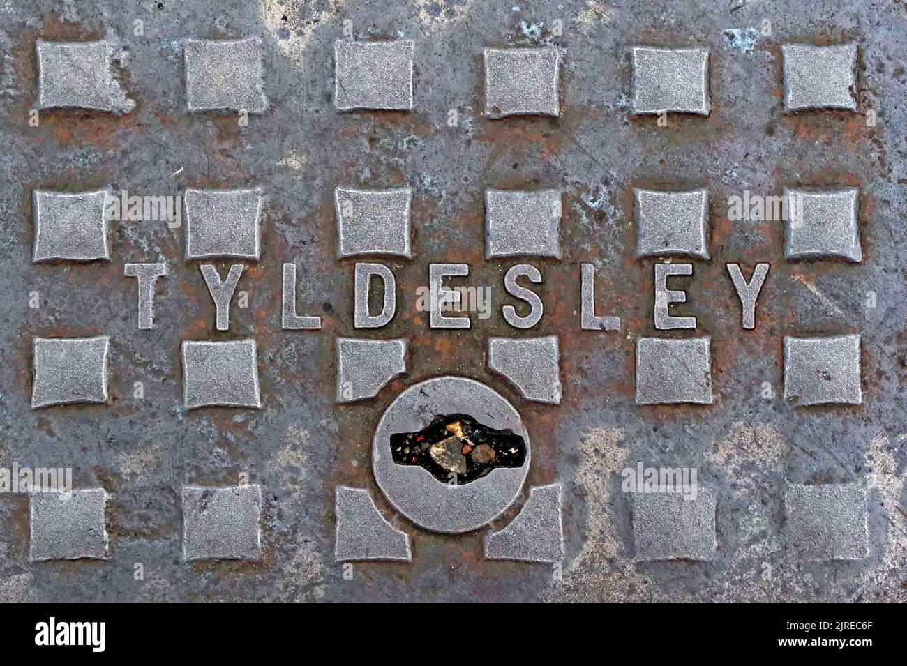 Embossed cast iron street grid, manhole cover, Tyldesley, ironworks, foundry, Manchester, Lancashire, England, UK, M29 8DZ Stock Photo