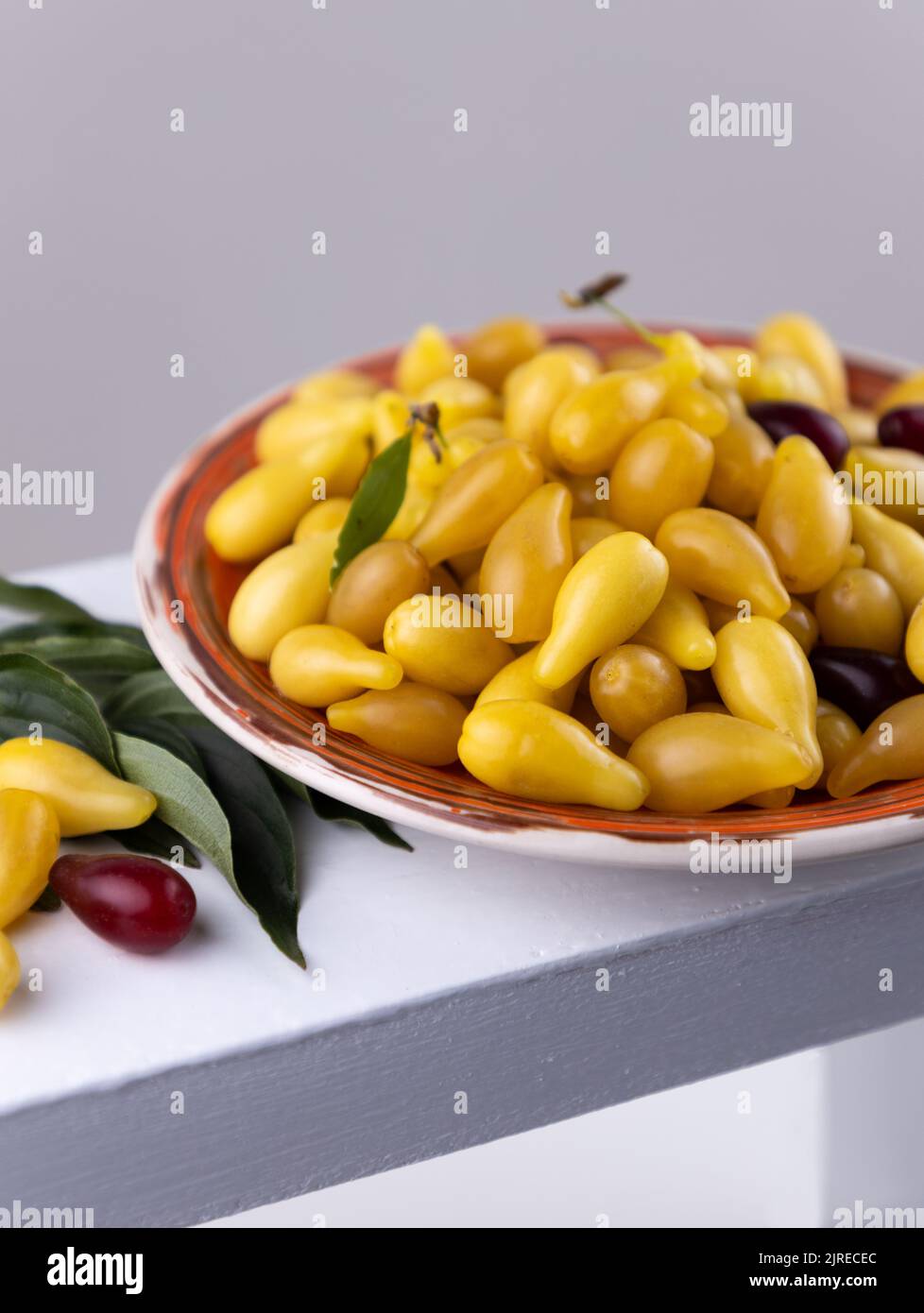 Yellow and red Cornelian cherry dogwood or cornus mas beries. Healthy low carb berry. Pulpy, sweet and sour fruit. Selective focus. Stock Photo