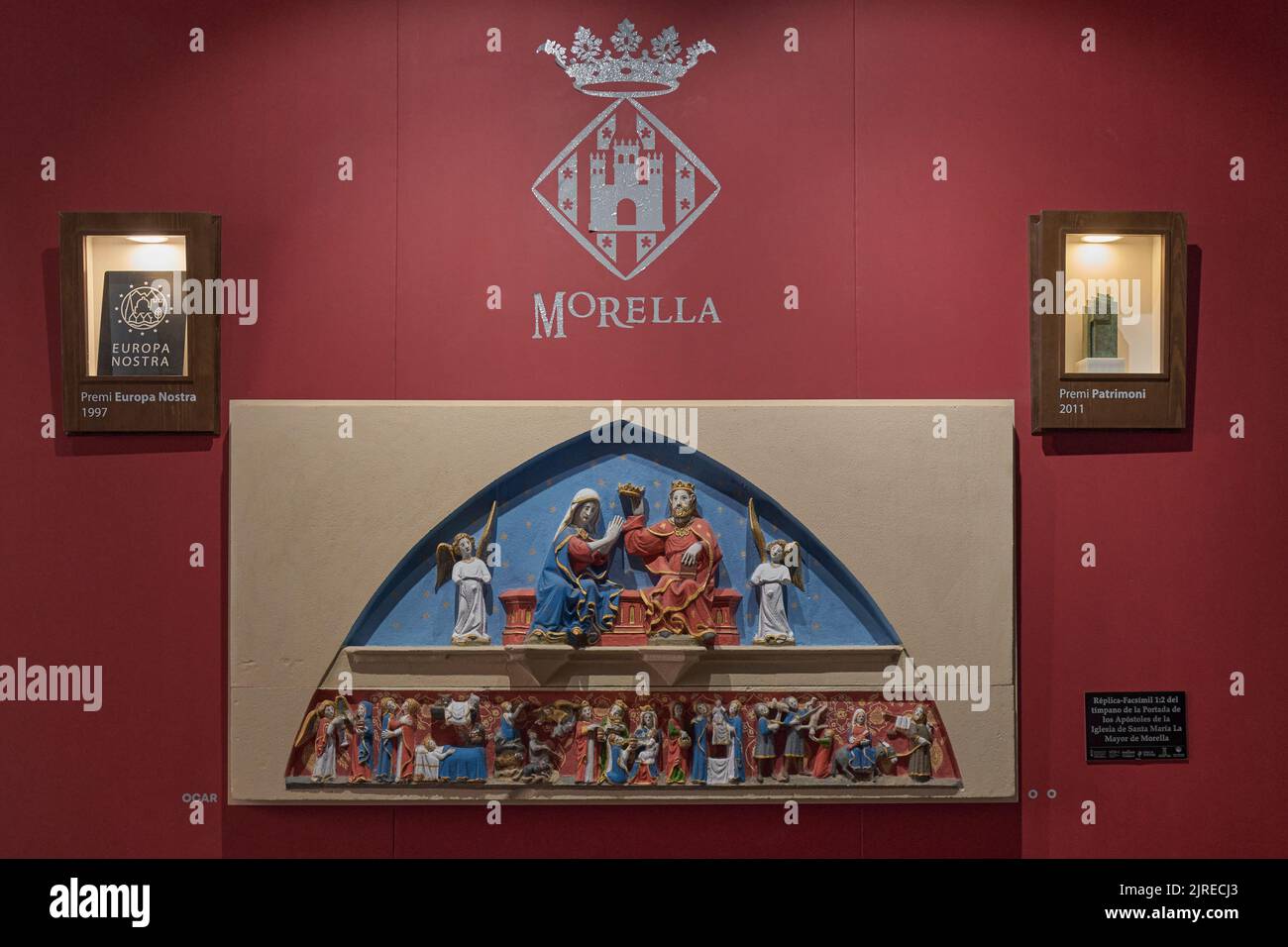 Mural in the Morella town hall with the Europa Nostra award and the 2011 Heritage award and the replica of the tympanum of the Santa Maria la Mayor Stock Photo