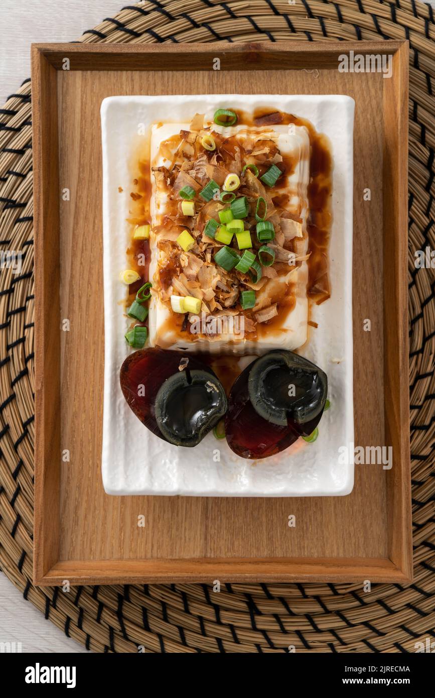 Delicious Chilled tofu and century egg food with soy sauce and bonito