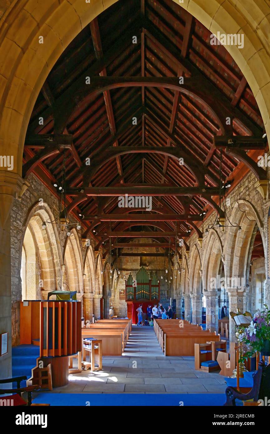 Newbiggin by the sea Northumberland beautiful seaside village with 13th century St Batholomews church looking West down the nave toward the organ Stock Photo