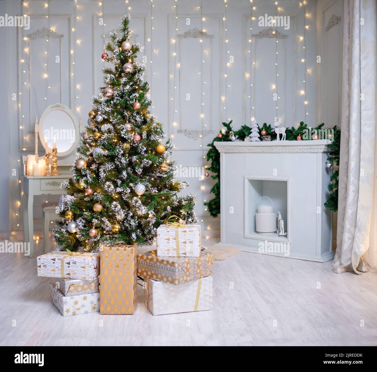 Beautiful holdiay decorated room with Christmas tree with presents under it. Stock Photo