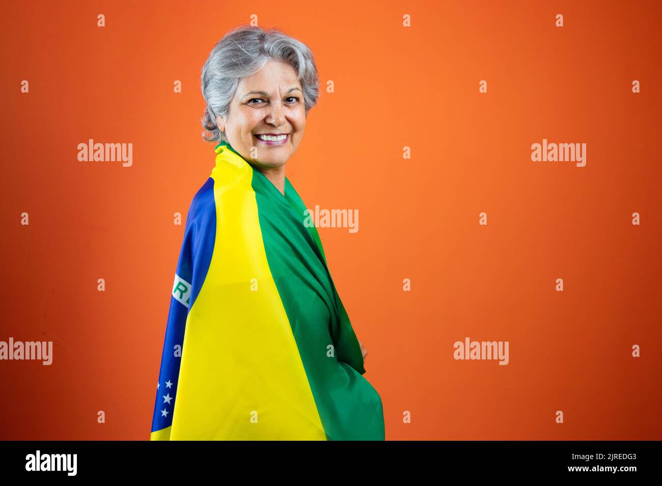 Mature Woman with Gray Hare Holding Brazil Flag Stock Photo