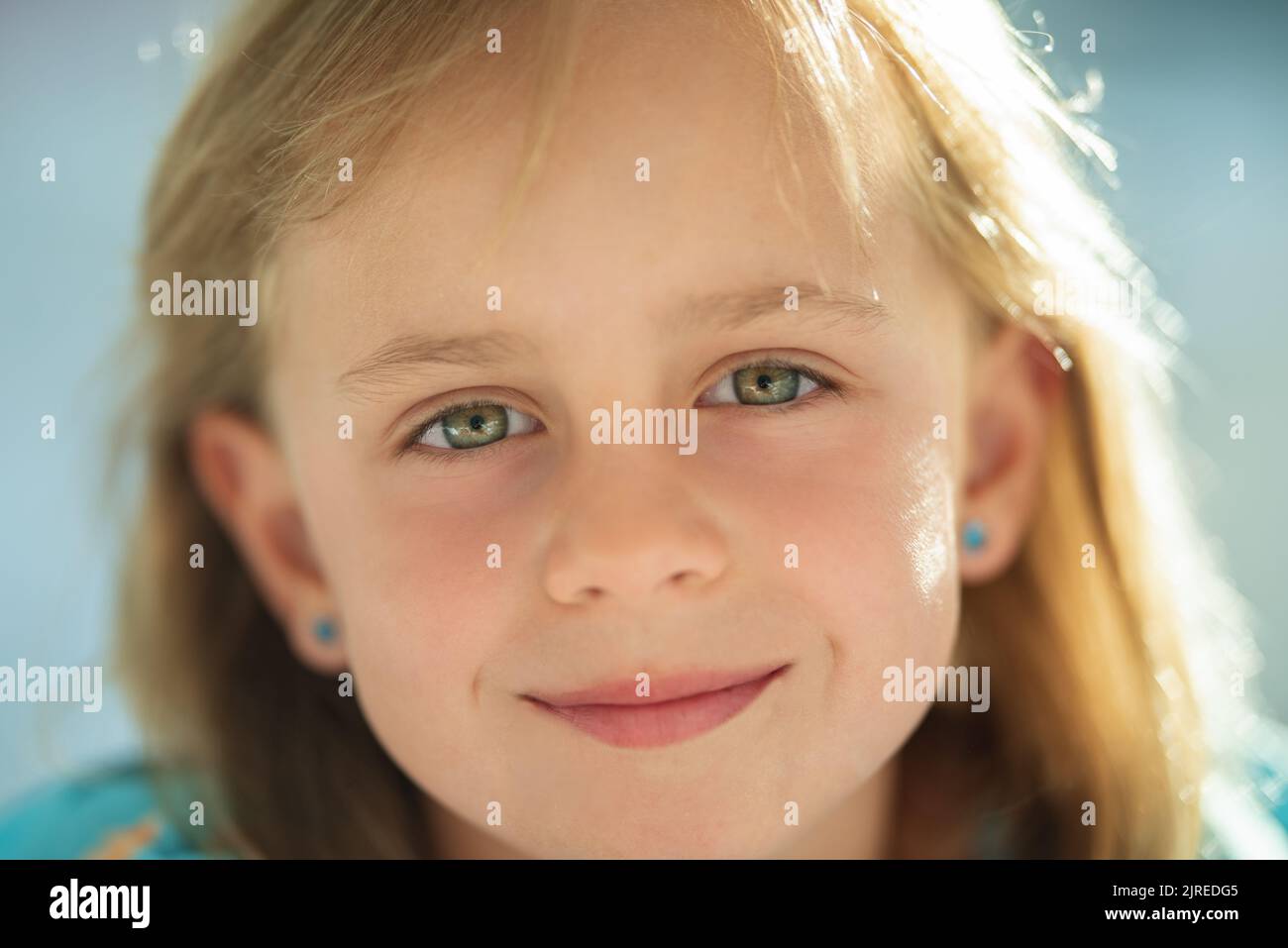 cute little girl smiling in a park close-up Stock Photo