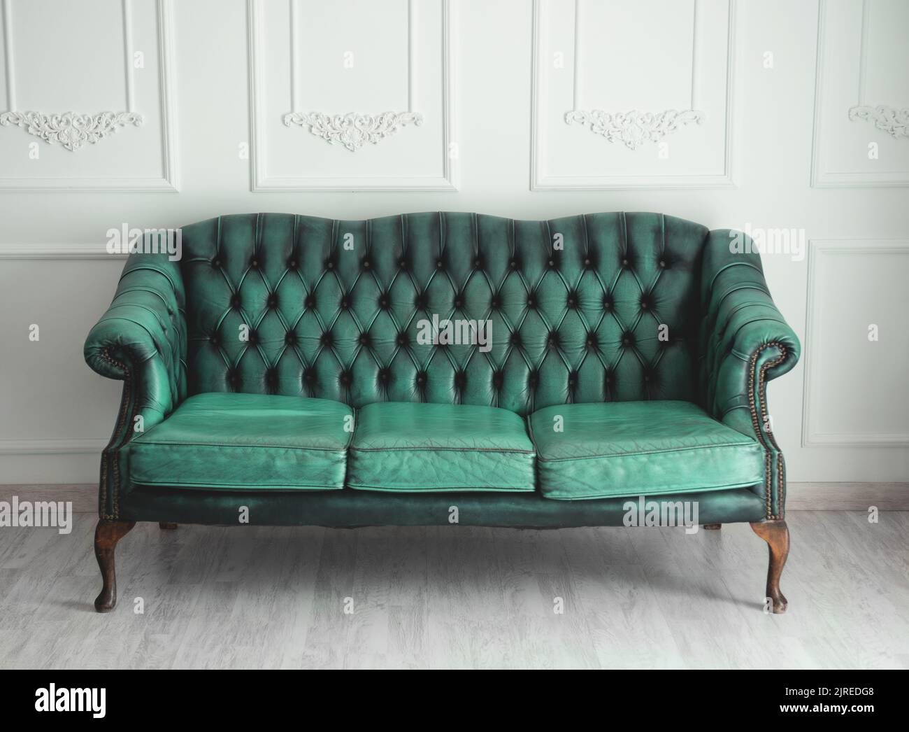 Beautiful antique blue sofa on a light background. Stock Photo