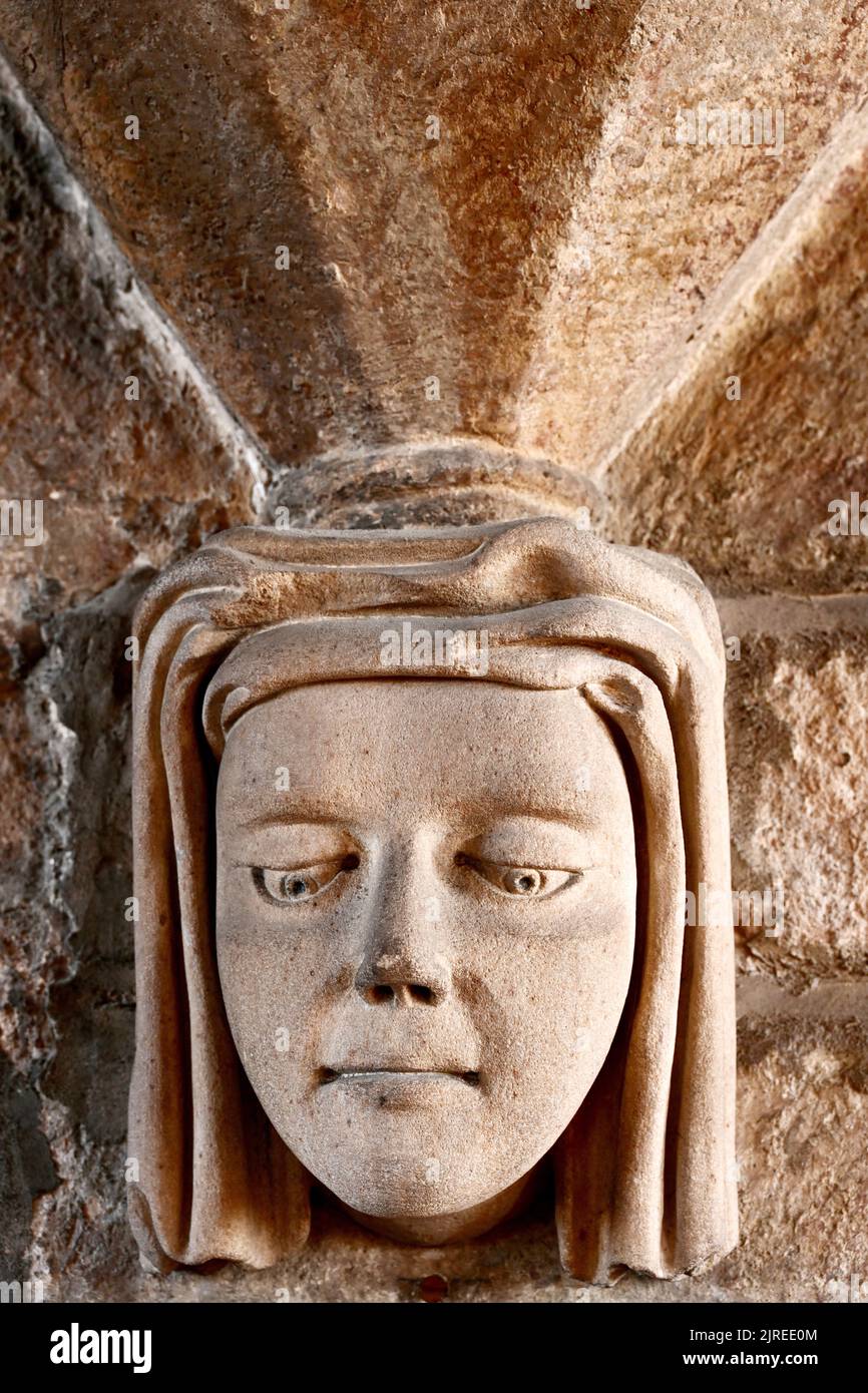 Newbiggin by the sea Northumberland beautiful seaside village with 13th century St Batholomews church with a charming stone face carving of a young wo Stock Photo