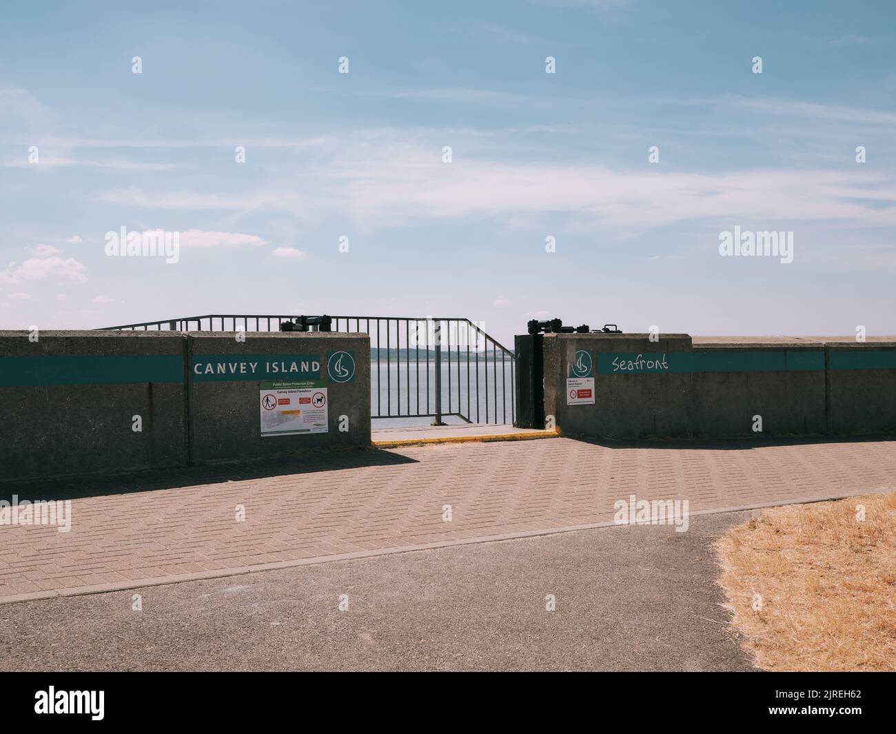 The concrete seawall flood defence and gate opening of Canvey Island, Thames Estuary, Essex, England UK Stock Photo