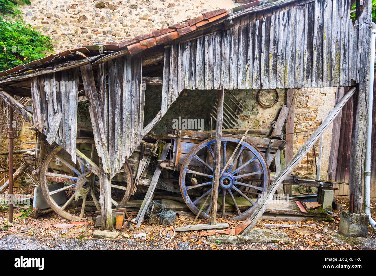 Old donkey farmcarts in rustic farmyard shelter - Le Bost, Ambazac, Haute-Vienne (87), France. Stock Photo