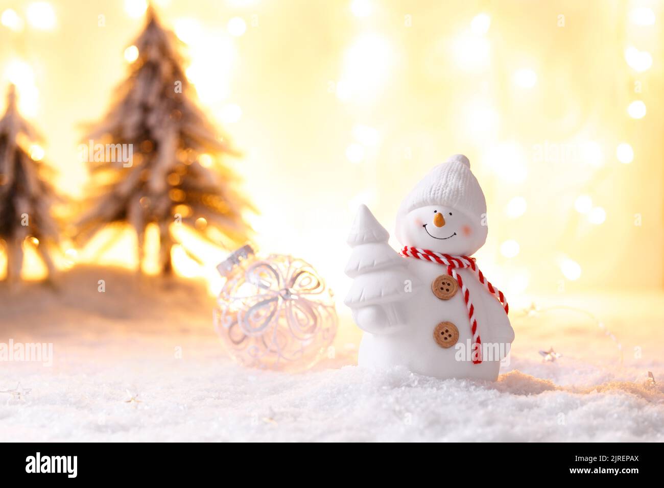 Snowman toy on the snow Christmas or New Year festive greeting card template Stock Photo