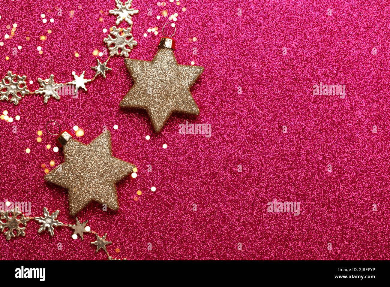 Christmas golden ornaments on the red glitter background with copy space top view Stock Photo